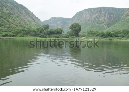 Two Green Mountain reflection in river water. A valley of nature. water wave .