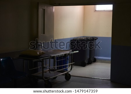 empty stretcher trolley in the shadows cinematic photography dark concept.