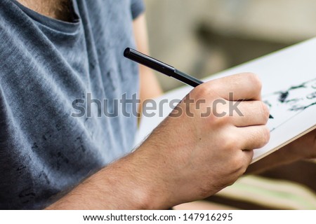 Male artist drawing Royalty-Free Stock Photo #147916295