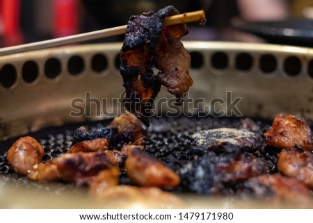Overcooked food with black tar substance. Eating unhealthy burnt food is dangerous & can cause cancer. Carcinogenic comes from barbecue which is prone to cause cancer. Unhealthy lifestyle concept.  Royalty-Free Stock Photo #1479171980