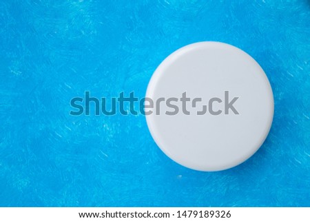 Top view round white plastic cream jar on a blue background. Cosmetic glass jar Mock up. Skin care bottles for gel, liquid, lotion, cream. Beauty product package.Body Butter Jar.High resolution photo.