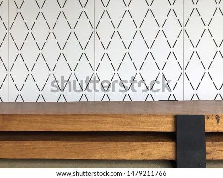 Wooden console and white wall