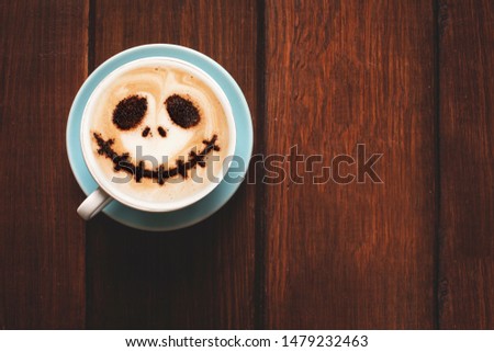 Cup of coffee with scary Jack's face. Halloween background. Halloween party. 