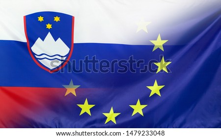 Slovenia and European Union relations concept with diagonally merged real fabric flags
