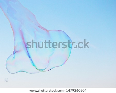 Soap bubbles on a blue sky illuminated by the sun texture background with copy space stock photo image