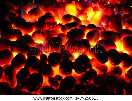 BBQ Grill Pit With Glowing And Flaming Hot Charcoal Briquettes, Food Background Or Texture, Close-Up, Top View 