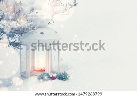 Christmas composition - a lantern with a burning candle and decorations under the Christmas tree, copy space, place for text