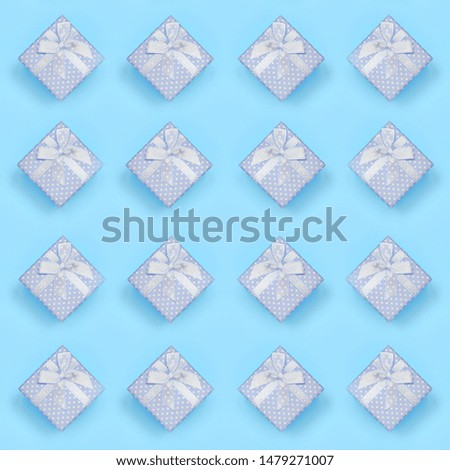A lot of blue gift boxes lies on texture background of fashion pastel blue color paper in minimal concept