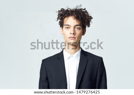 Man in a suit curly hair self-confidence modern office style