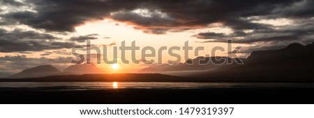 Panoramic picture of beautiful sunset in the mountains over a river valley in Iceland
