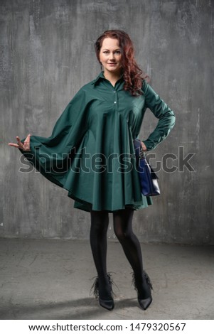 beautiful woman in fashionable clothes posing for the camera in the Studio.