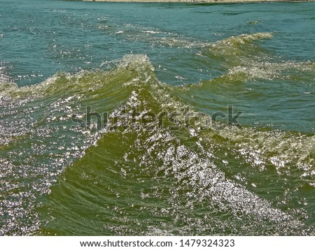 Waters of water from a motor boat in the river