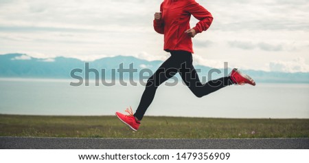 Sporty young fitness woman ultramarathon runner running on road Royalty-Free Stock Photo #1479356909
