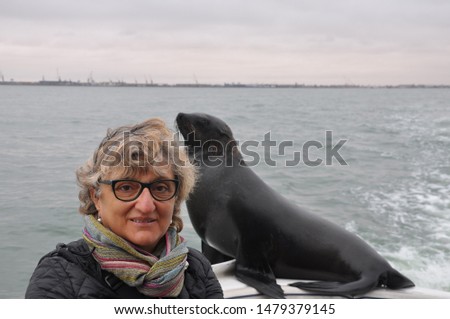 Adult woman on the boat with sea lion