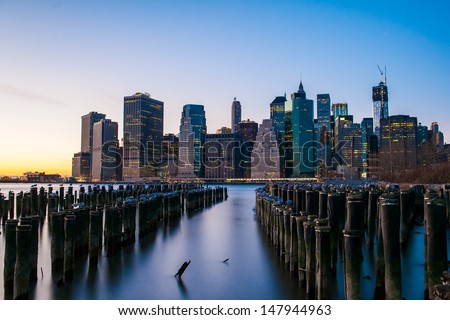 The buildings of Manhattan in front of east river at sunset