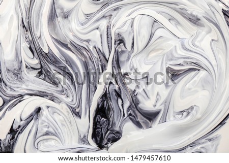 Mixing white and black paint, abstract pattern effect.