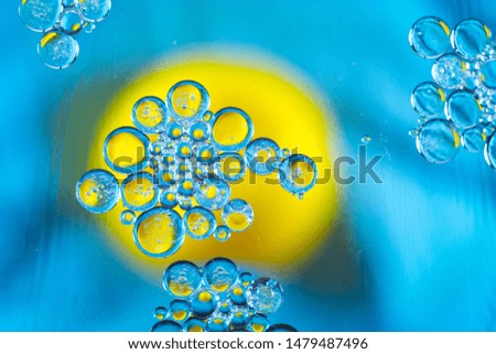 drops of oil in water on a blue background