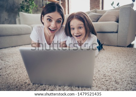 Close up photo of shocked people student looking netbook having foxy ginger hair wearing white t-shirt scream lie floor in house indoors