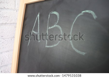 classroom chalkboard with white brick background
