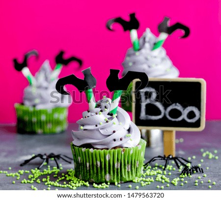 Halloween witch cupcakes decorated with cream and witch legs
