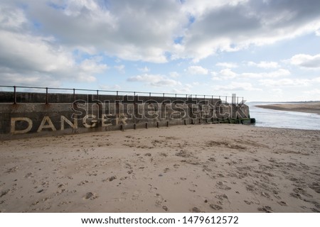 Danger keep off. Coastal Drowning hazard. Sea wall Gorleston UK. Warning sign at Gorleston-on-sea public beach near Great Yarmouth Norfolk.