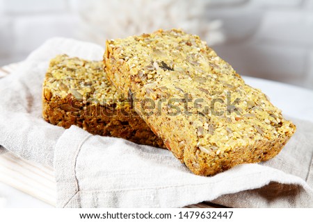 Close up view on gluten free bread served on grey cloth above white brick wall. Homemade bakery concept, healthy vegan food. Copy space for design. Picture for recipe