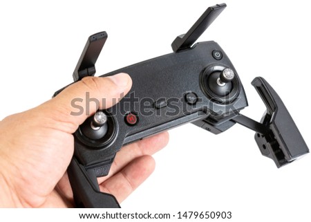 Drone controler in the hand isolated above white background