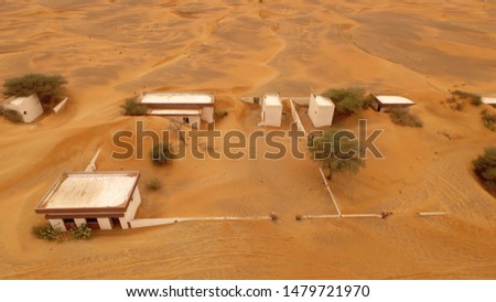 Abandoned village covered by sand dunes aerial view