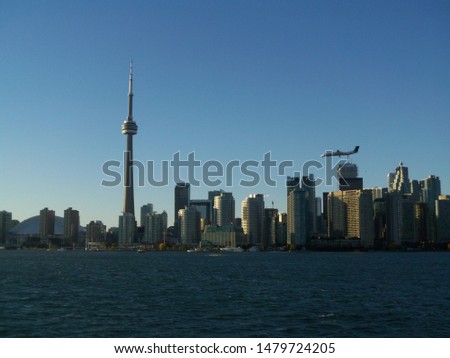 Airplane flying over Downtown Toronto Ontario Canada skyline view from Lake Ontario