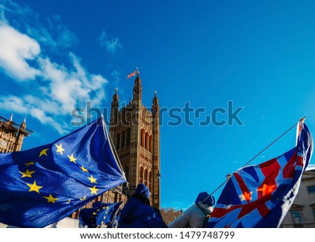 European Union and British Union Jack flag flying in front of Houses of Parliament at Westminster Palace, London - Brexit EU referendum theme Royalty-Free Stock Photo #1479748799