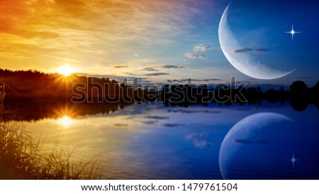 the romantic moon over water . Crescent moon with beautiful sunset background . Generous Ramadan . New moon.  Royalty-Free Stock Photo #1479761504