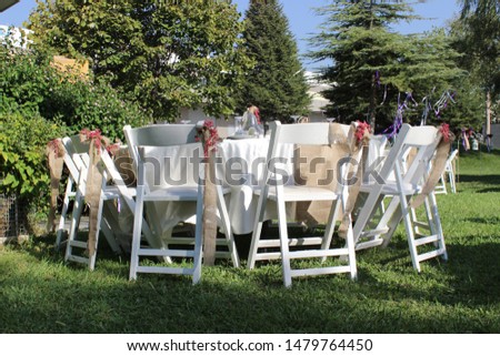 Elaborately crafted wedding dining table with natural ornamented wooden white chair