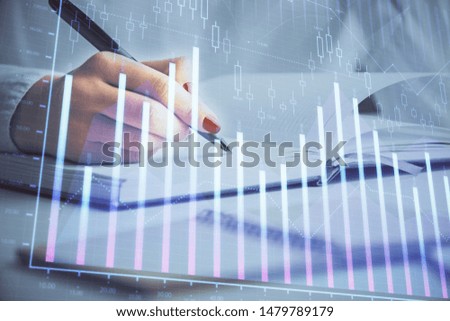 Multi exposure of woman's hands making notes with forex graph hologram. Concept stock market analysis.