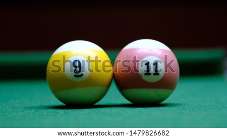 Snooker ball on green flannel with number 9-11