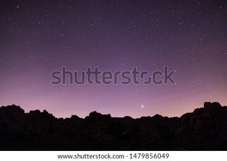 Joshua Tree National Park silhouette hills stars purple sky 