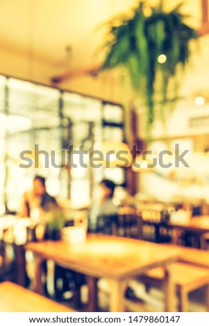 Vintage tone abstract blur image of Cafe or Restaurant  on day time with bokeh for background usage .
