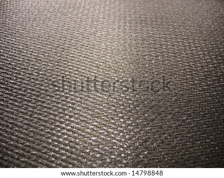 Real carbon fiber in its raw form - this is the material that is used to make durable and strong parts for cars, boats, bikes, and even photography equipment. Shallow depth of field.
