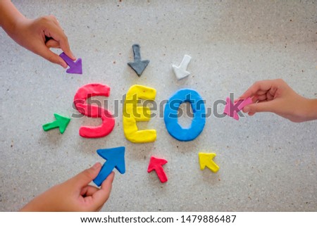 SEO Search Engine Optimization concept. The Plasticine molding that was molded into the SEO alphabet, surrounded by arrows. Arrow handle pointing to SEO.