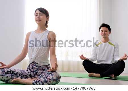Couple doing Yoga in their twenties
