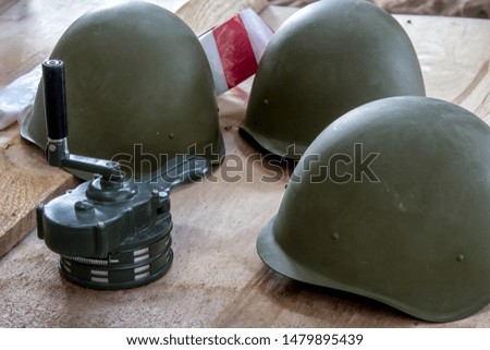 Russian military helmet on a wooden background. The classic form of a helmet to protect the head from splinters.