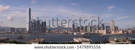 Beautiful Kowloon Hong Kong recognizable skyline Panorama, Victoria Harbor with piers on sunny day 