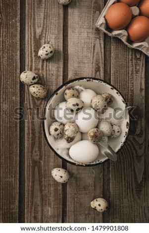 
Chicken eggs. Minimalistic still life on a dark old vintage wooden background. Top view Selective focus. Cardboard packaging for eggs.