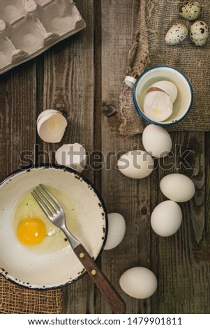 
Chicken eggs. Minimalistic still life on a dark old vintage wooden background. Top view Selective focus. Cardboard packaging for eggs.