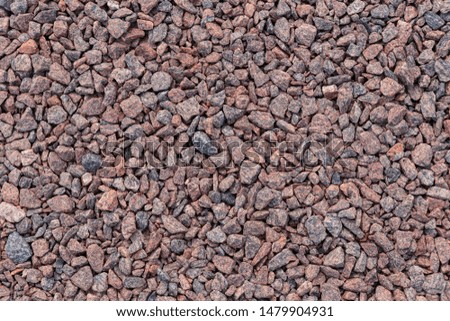 Background of granite stones. The texture of the gravel.