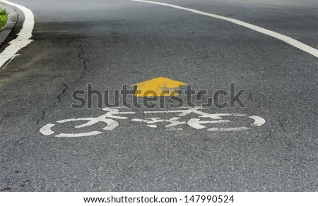 White Bicycle symbol and white line on the road