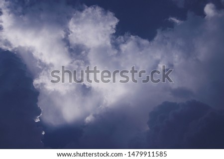 Dark blue sky and cloud with light background.
