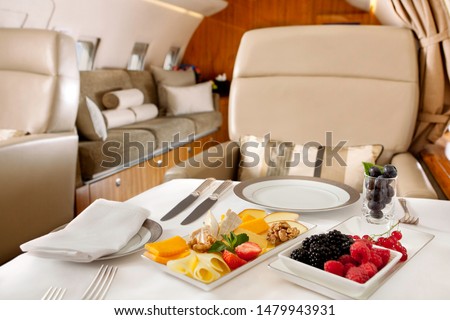 Food served on board of business class airplane. Royalty-Free Stock Photo #1479943931