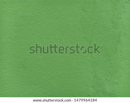 The background is made of patterned green concrete.