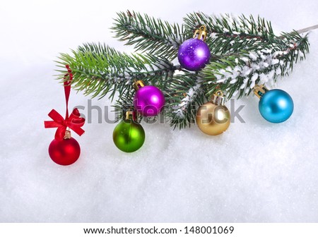 christmas snow background with colorful balls and fir branch, copy space for your text 