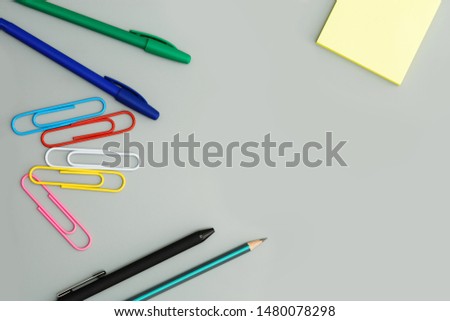 School supplies on a gray background. Top view.